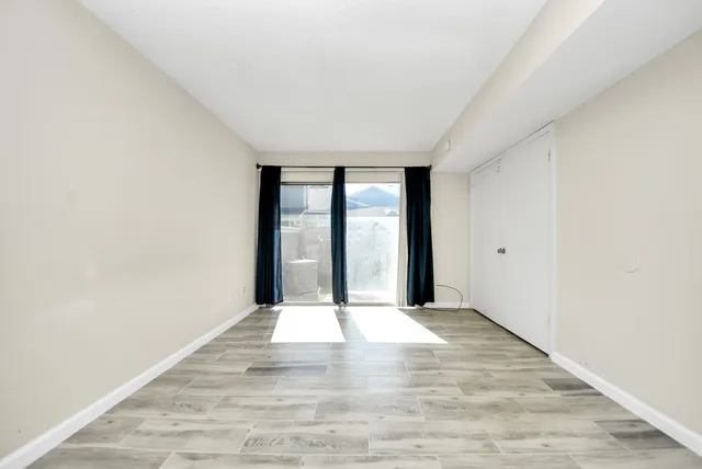 wooden floor in an empty room with a window