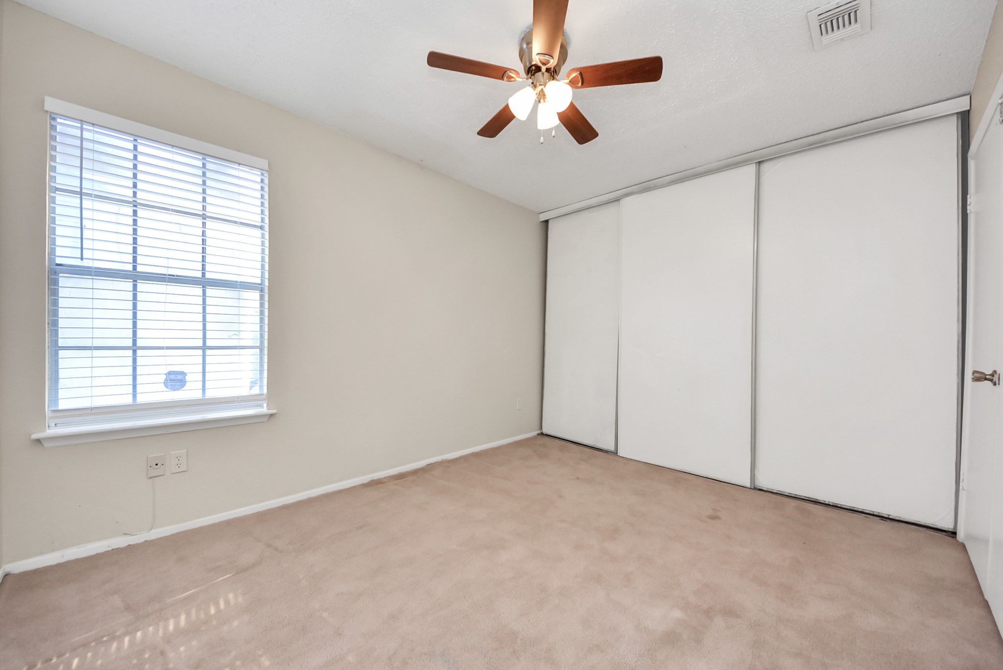 12232 Copper Tree Pvt Lane, Unit 122 Houston, TX 77035 - Photo 34 of 41 an empty room with windows and fan