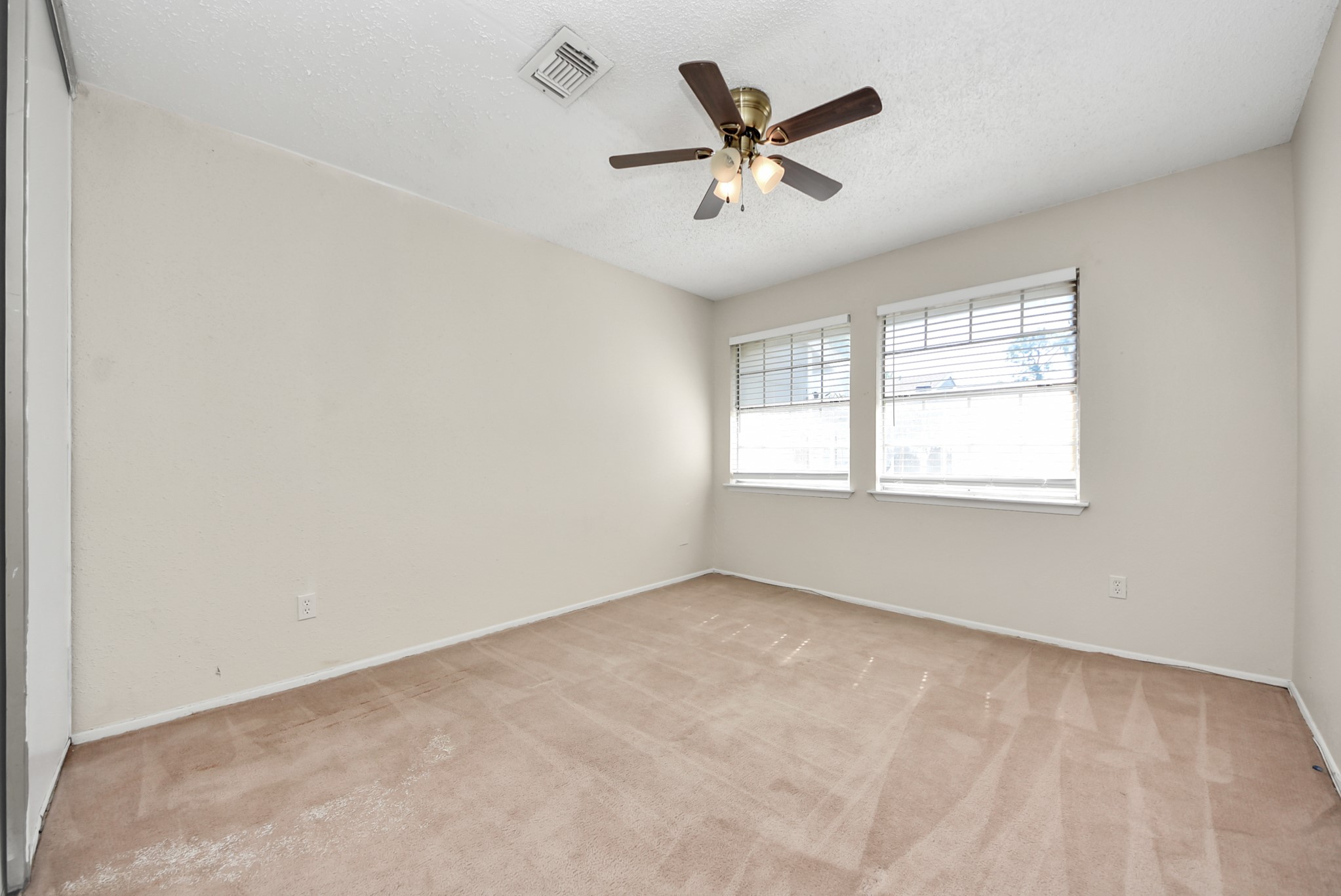12232 Copper Tree Pvt Lane, Unit 122 Houston, TX 77035 - Photo 35 of 41 an empty room with window and ceiling fan