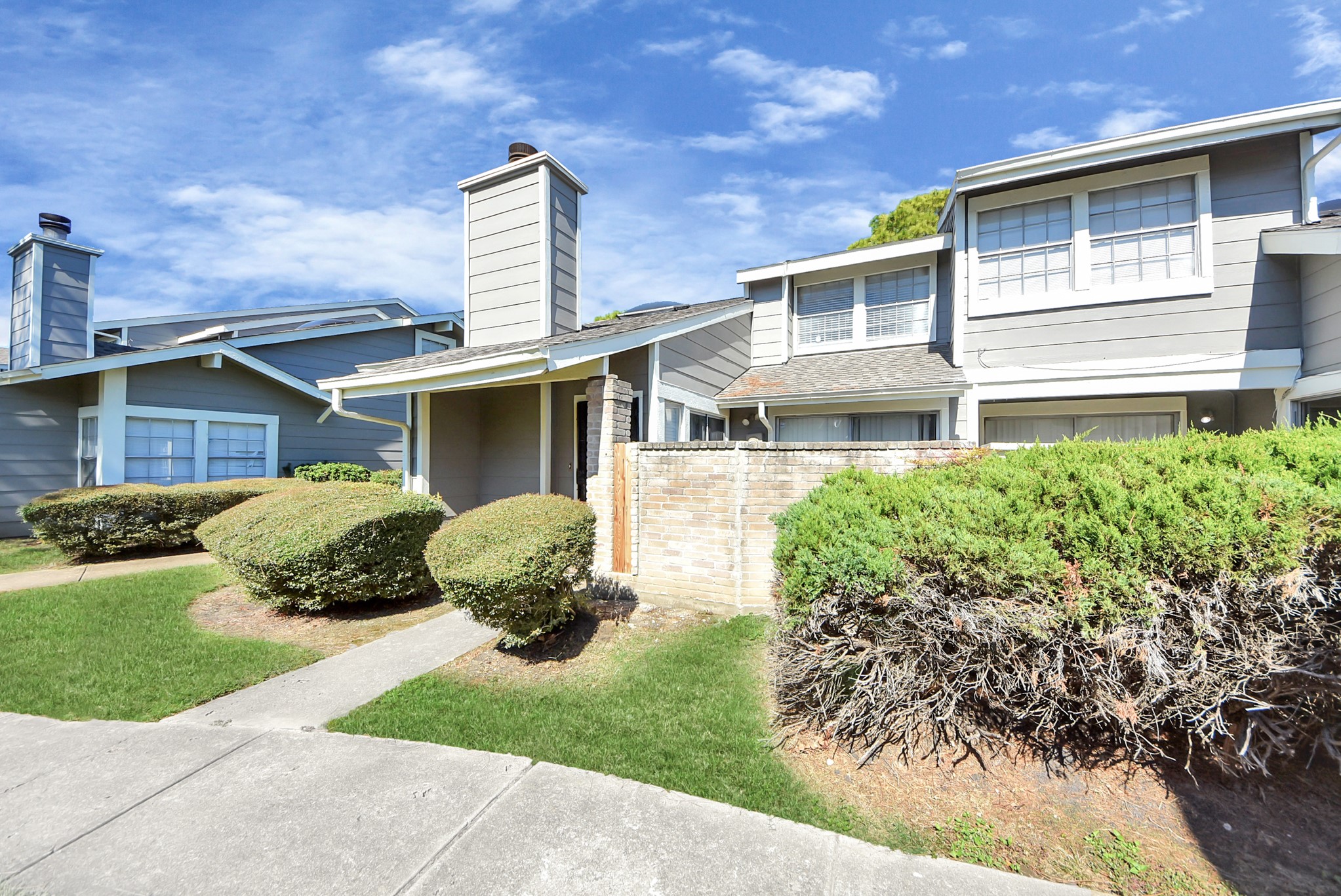 12232 Copper Tree Pvt Lane, Unit 122 Houston, TX 77035 - Photo 38 of 41 a front view of a house with a yard and potted plants