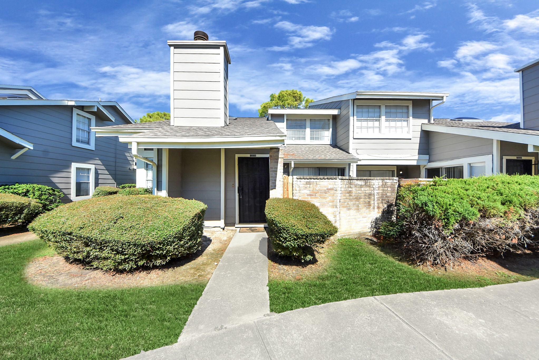 12232 Copper Tree Pvt Lane, Unit 122 Houston, TX 77035 - Photo 40 of 41 a front view of a house with a yard and potted plants