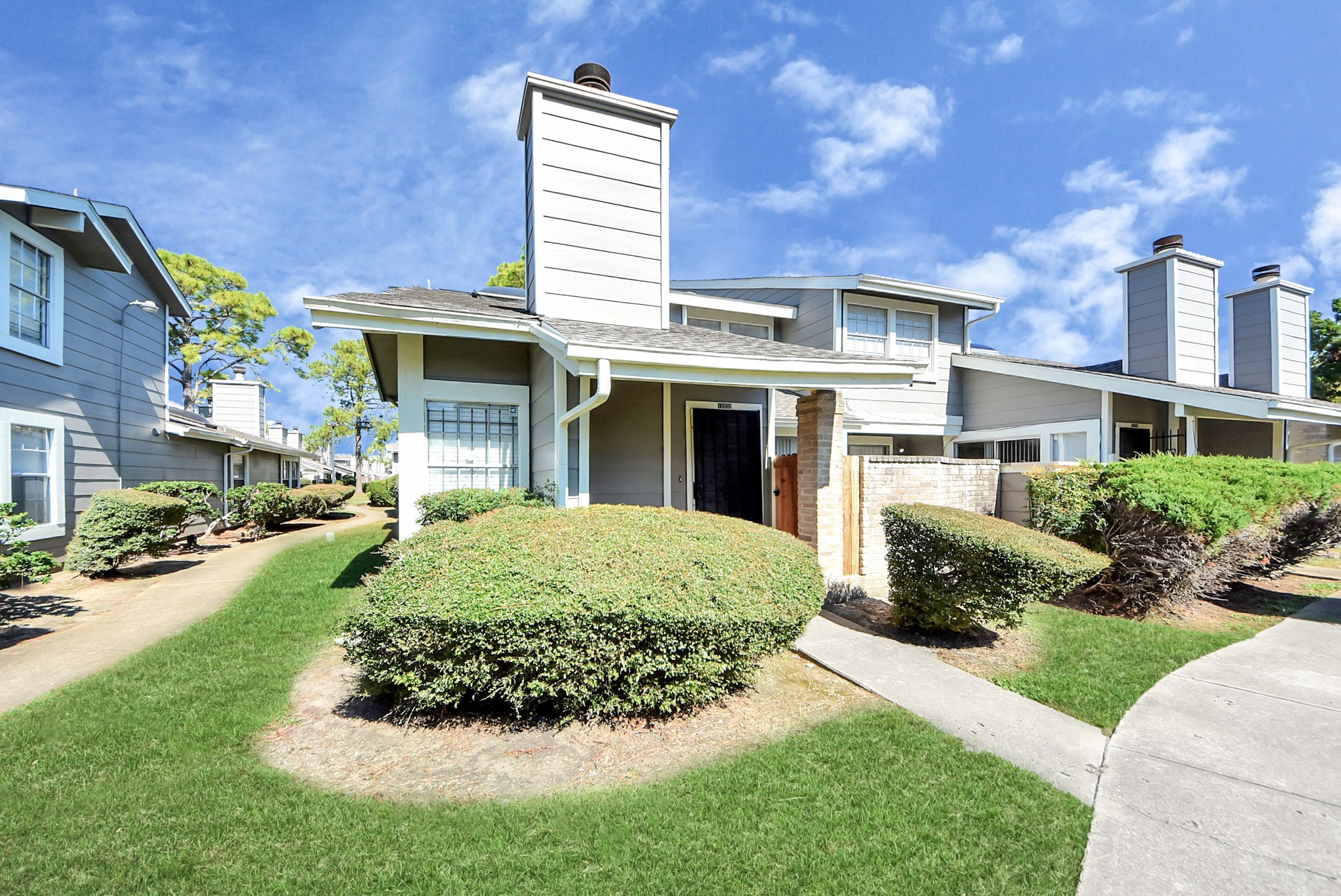 12232 Copper Tree Pvt Lane, Unit 122 Houston, TX 77035 - Photo 41 of 41 a front view of a house with a yard and potted plants
