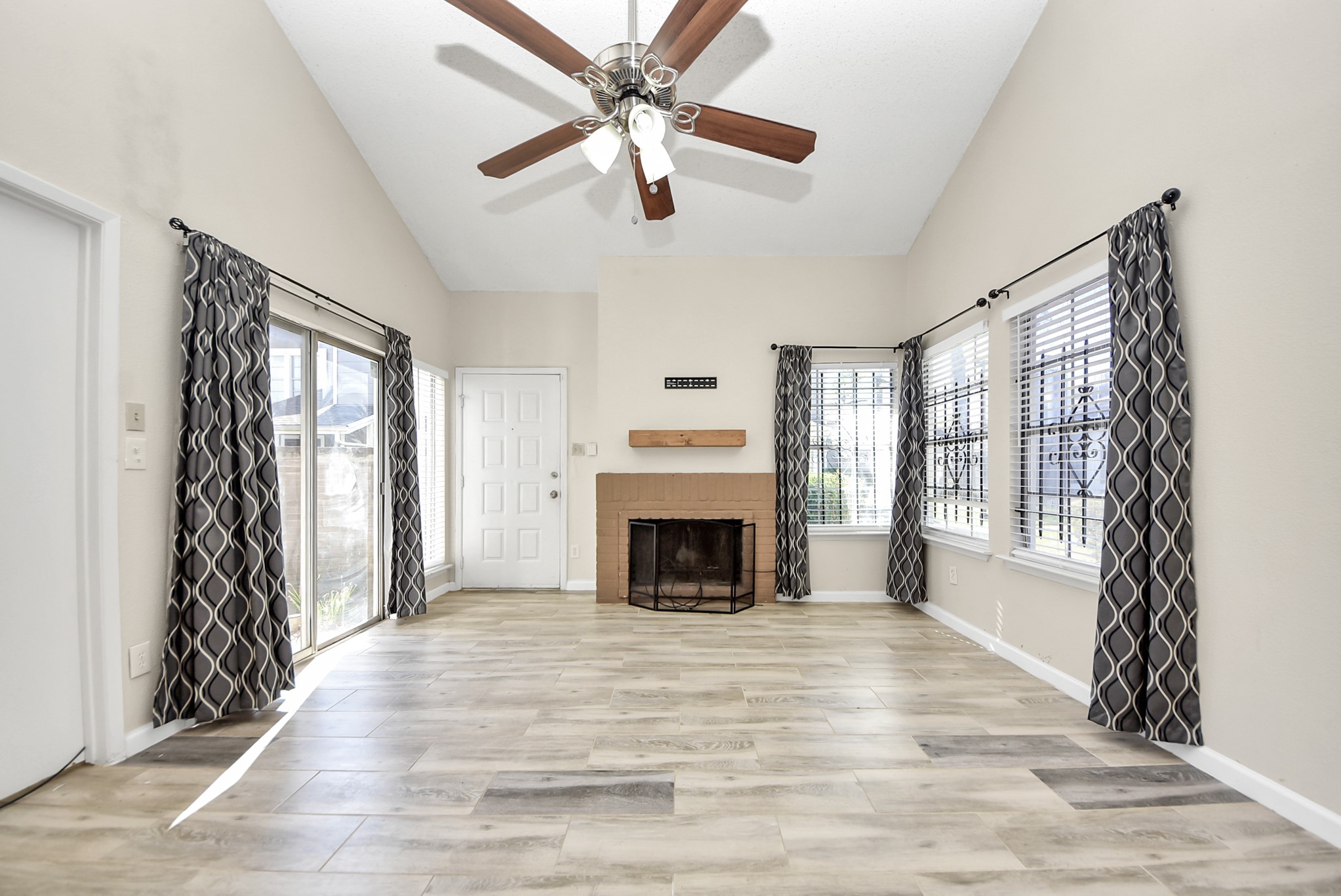 12232 Copper Tree Pvt Lane, Unit 122 Houston, TX 77035 - Photo 5 of 41 a view of an empty room with window and fire place