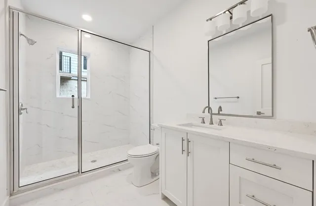 a bathroom with a shower sink and toilet