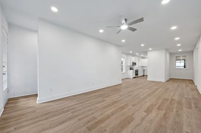 a view of a kitchen with a sink and a refrigerator