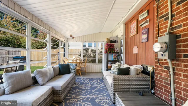 a balcony with furniture and a potted plant