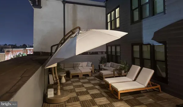a balcony with table and chairs