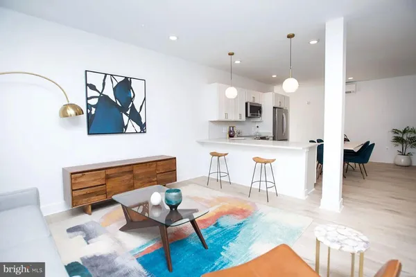 a living room with kitchen island furniture and a wooden floor