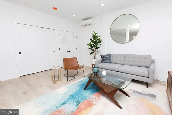 a living room with a couch and a potted plant