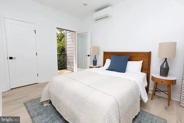 a bedroom with a bed and a potted plant