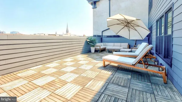 a view of a terrace with wooden floor and city view