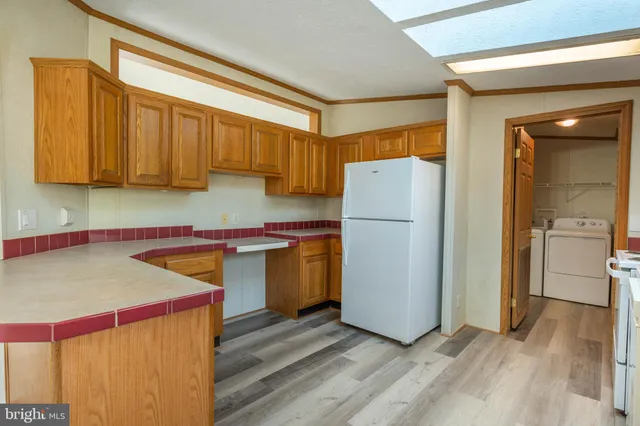 a kitchen with a refrigerator a stove and a sink