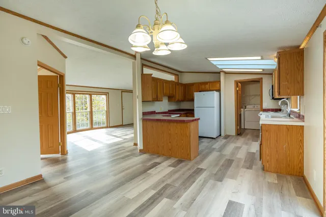 a kitchen with a refrigerator and a stove top oven
