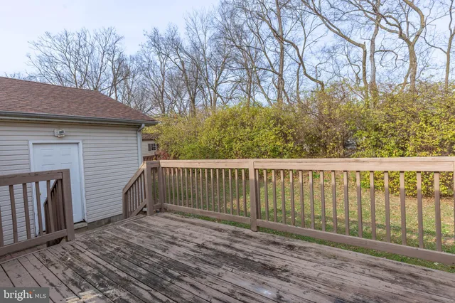 a balcony with wooden floor and fence