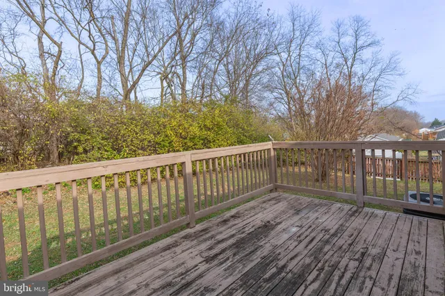 a balcony with wooden floor and fence