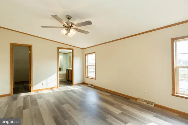a view of a livingroom with a window and a ceiling fan