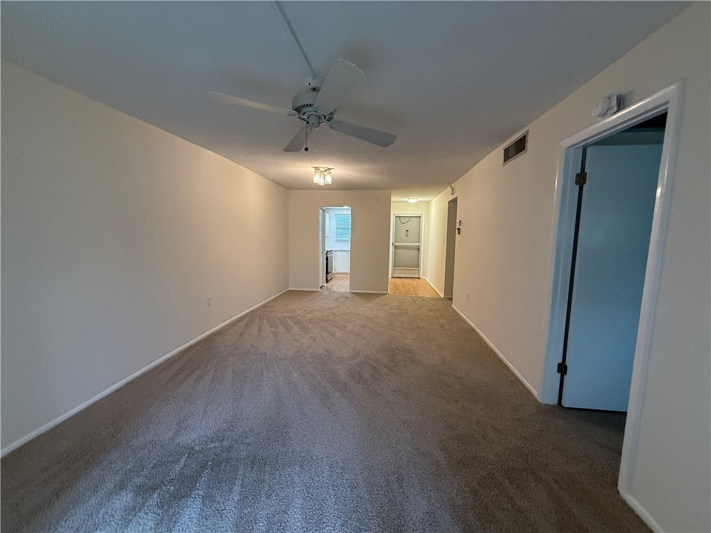 1100 Ponce De Leon Circle, Unit N208 Vero Beach, FL 32960 - Photo 11 of 16 a view of a big room with windows and chandelier fan