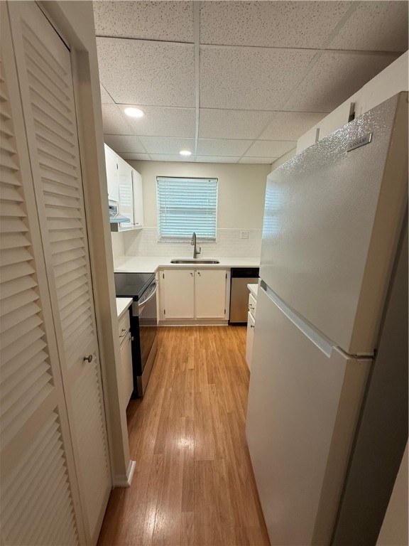 1100 Ponce De Leon Circle, Unit N208 Vero Beach, FL 32960 - Photo 9 of 16 a kitchen with a sink a refrigerator and cabinets
