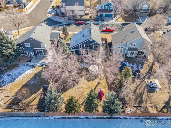 a front view of a house with a yard covered with snow