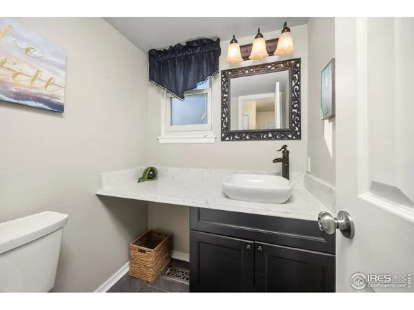 a bathroom with a sink vanity mirror and toilet