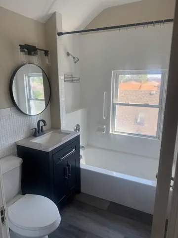 a bathroom with a toilet a sink and mirror