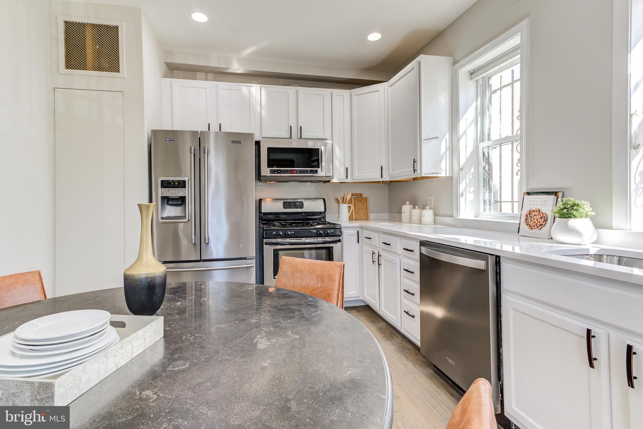 344 14th Street Southeast Washington, DC 20003 - Photo 12 of 31 a kitchen with stainless steel appliances a refrigerator stove and sink