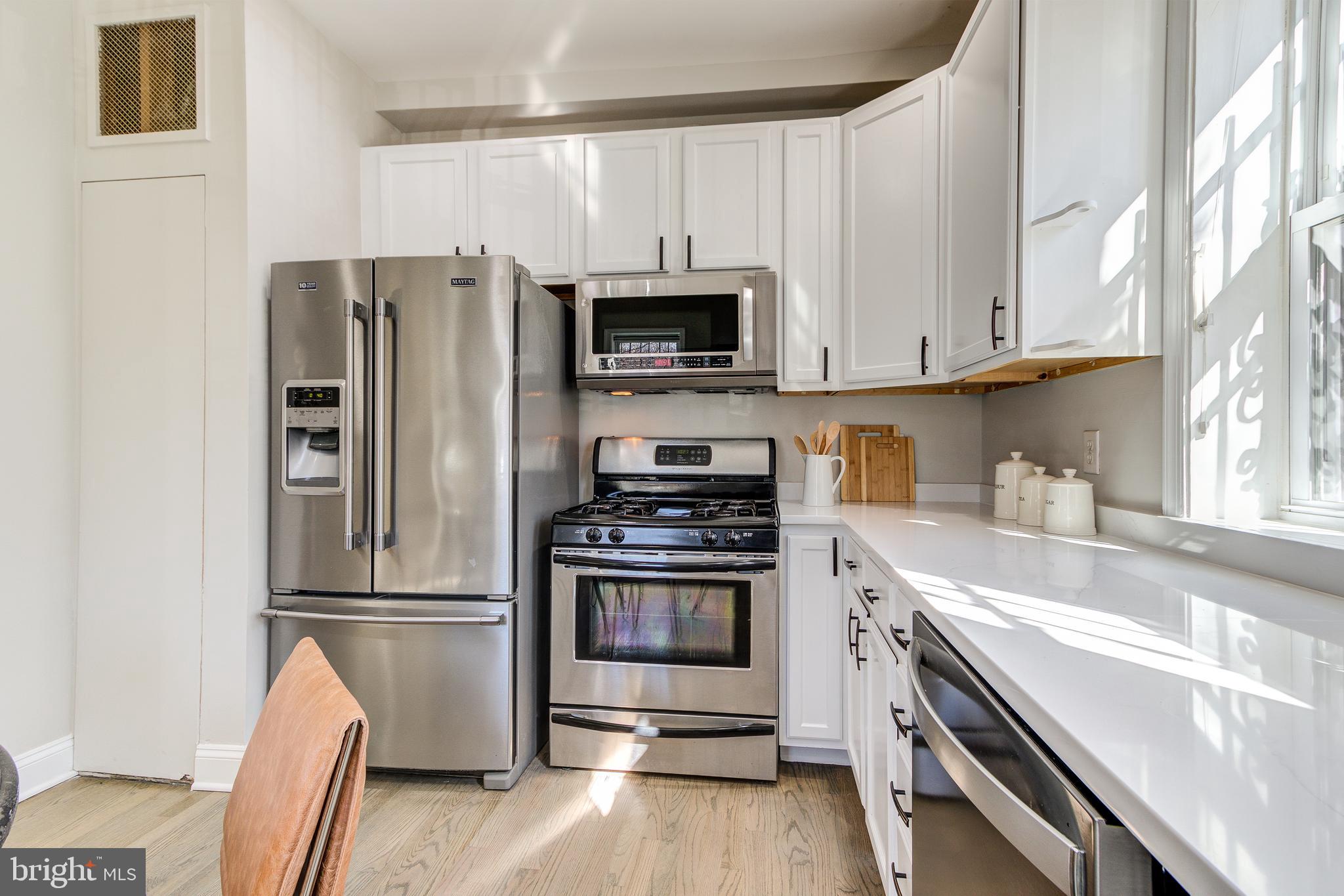 344 14th Street Southeast Washington, DC 20003 - Photo 13 of 31 a kitchen with stainless steel appliances granite countertop a refrigerator stove and sink