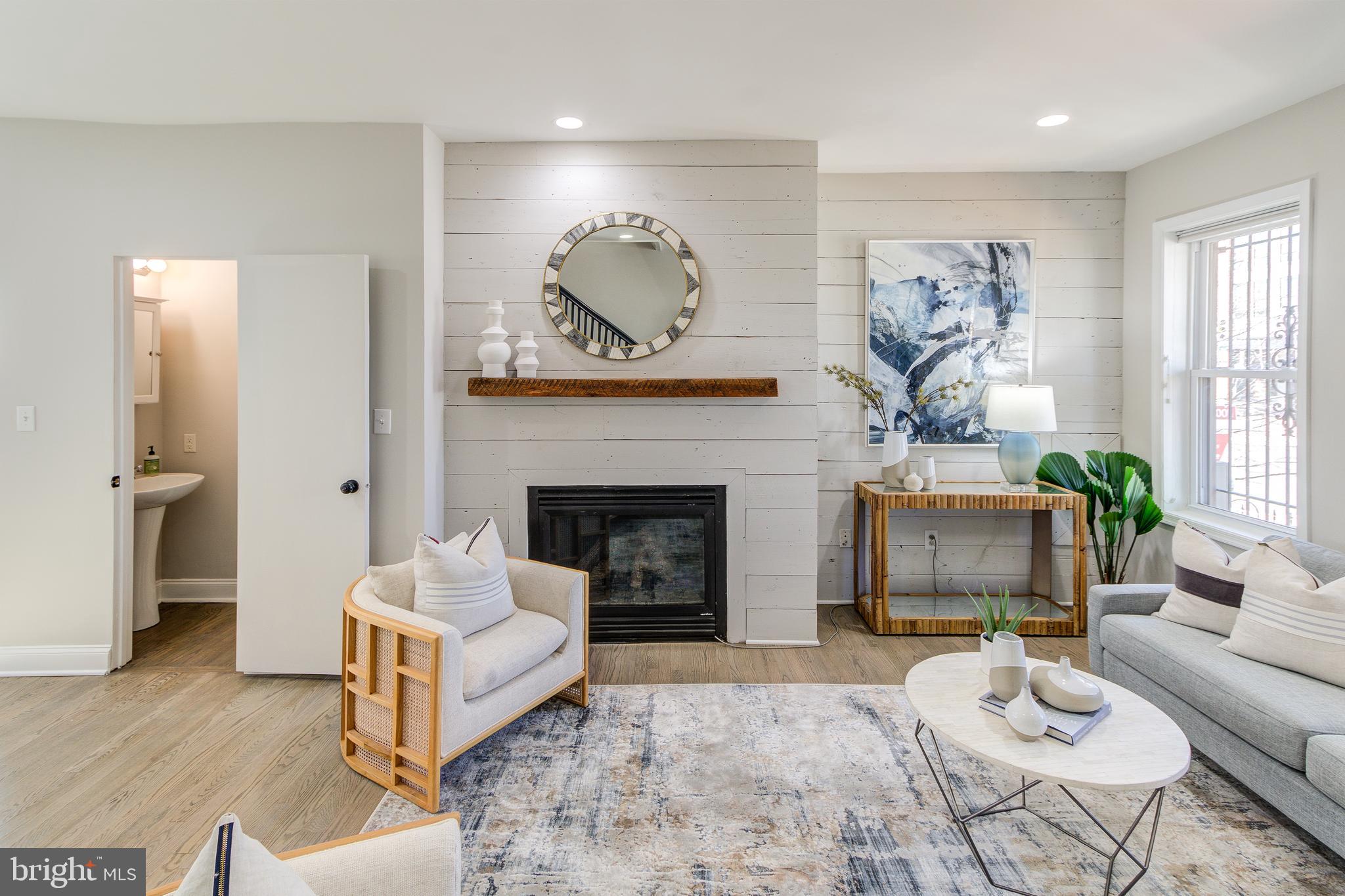 344 14th Street Southeast Washington, DC 20003 - Photo 16 of 31 a living room with furniture a fireplace and a large mirror