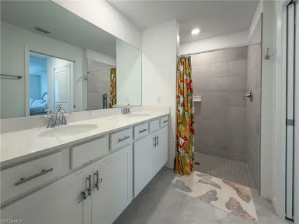 a bathroom with a shower sink and mirror