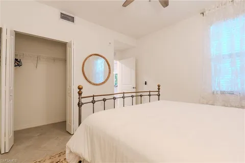 a bedroom with a bed and a mirror
