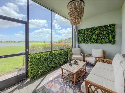 a living room with a floor to ceiling window next to a yard