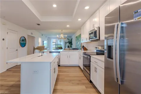 a kitchen with stainless steel appliances granite countertop a sink and refrigerator