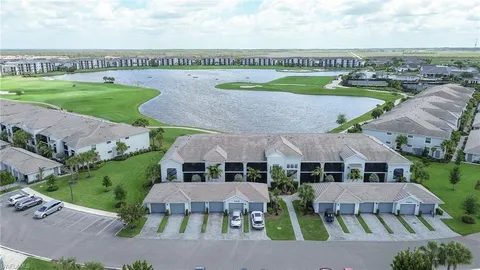 an aerial view of a house with a garden and lake view