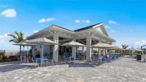 a patio with a table and chairs under an umbrella