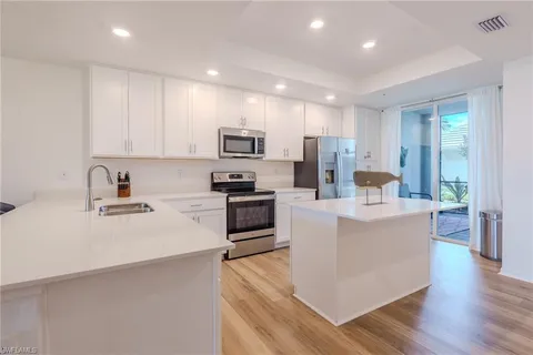 a large kitchen with stainless steel appliances