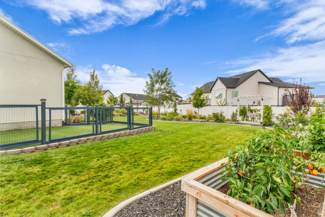 2454 West Jackson Street Mapleton, UT 84664 - Photo 4 of 63 Side fenced yard featuring a gate, dog run, and a garden