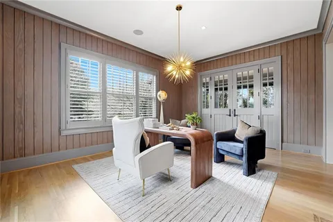 a view of a dining room with furniture wooden floor and chandelier