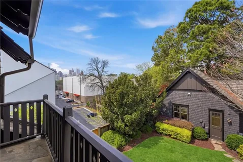 a view of a house with brick walls and a small yard