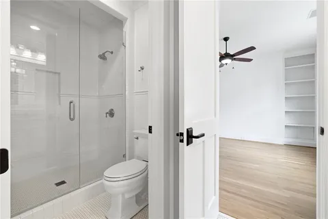 a bathroom with a shower a toilet and a shower