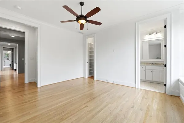 a view of a livingroom with wooden floor and a ceiling fan