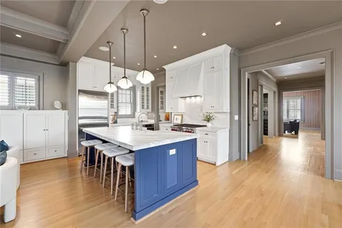 an open kitchen with a sink and breakfast area