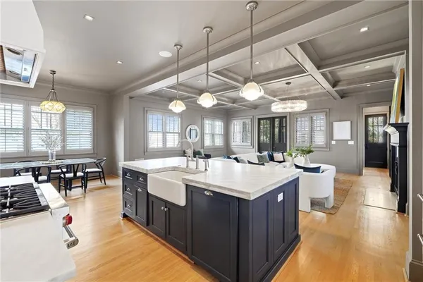 a large white kitchen with a large island