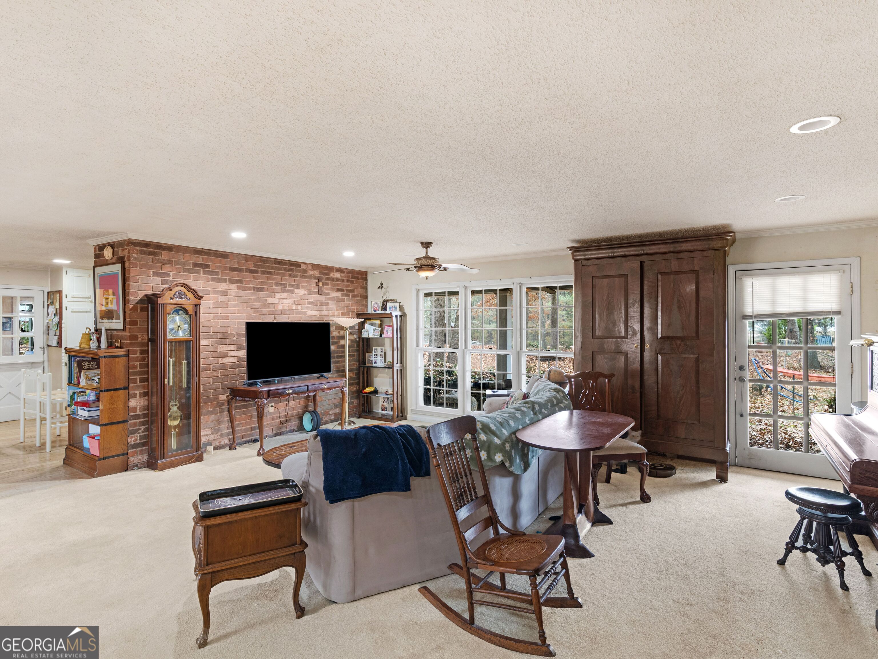 879 Rocky Creek Road Hampton, GA 30228 - Photo 16 of 29 a living room with furniture and a flat screen tv