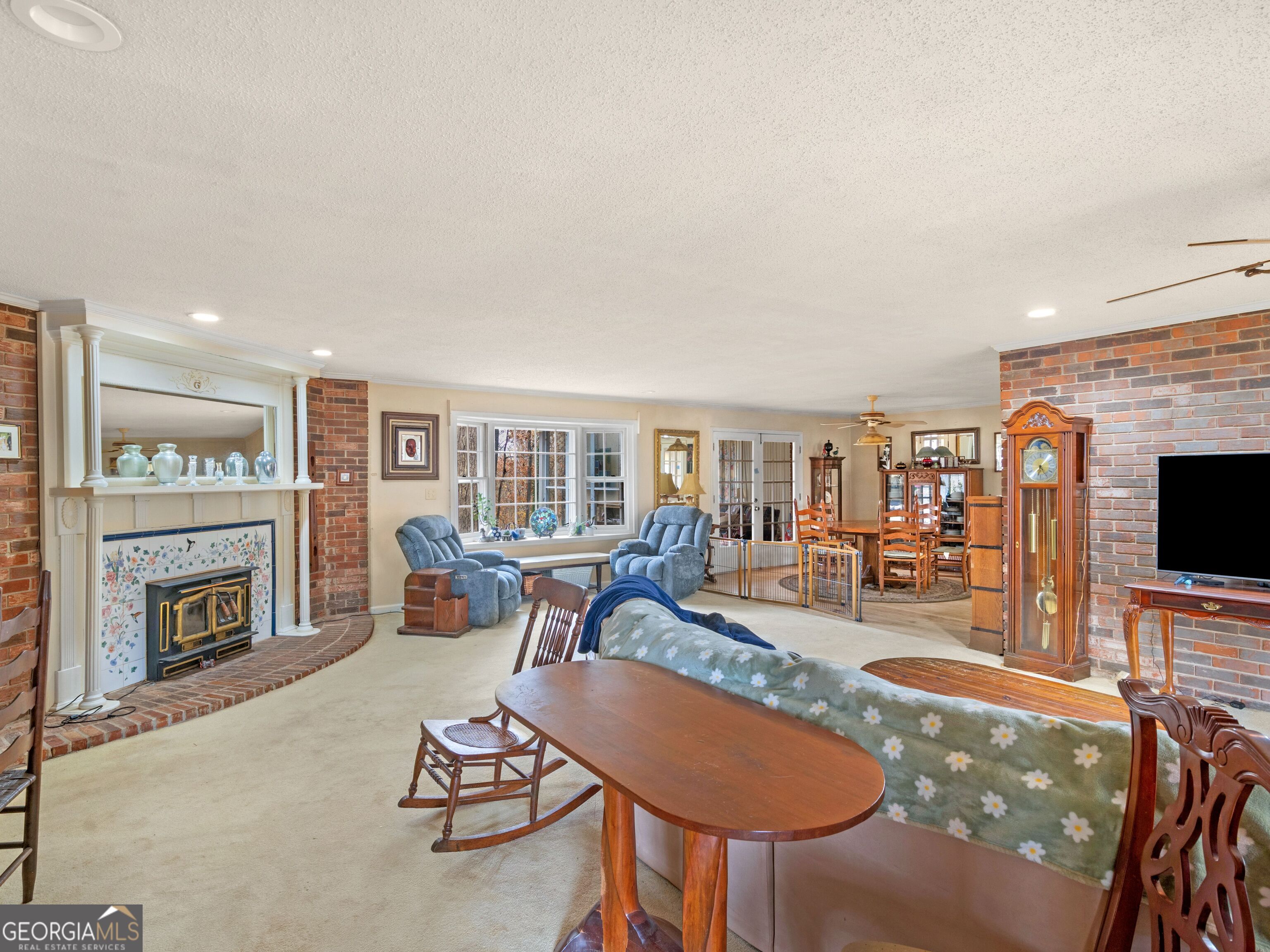 879 Rocky Creek Road Hampton, GA 30228 - Photo 17 of 29 a living room with furniture a fireplace and a flat screen tv