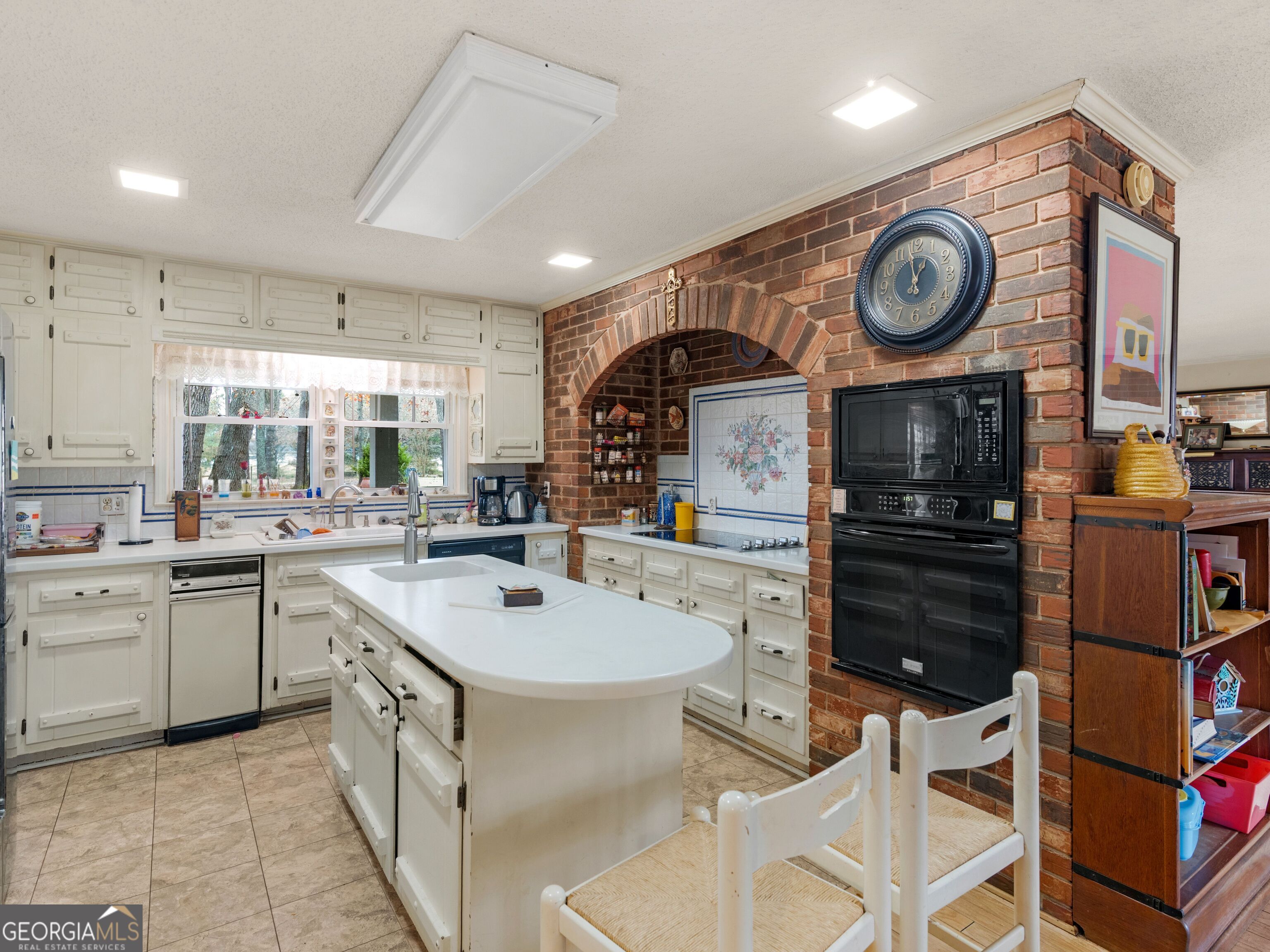 879 Rocky Creek Road Hampton, GA 30228 - Photo 5 of 29 a kitchen with a sink and cabinets