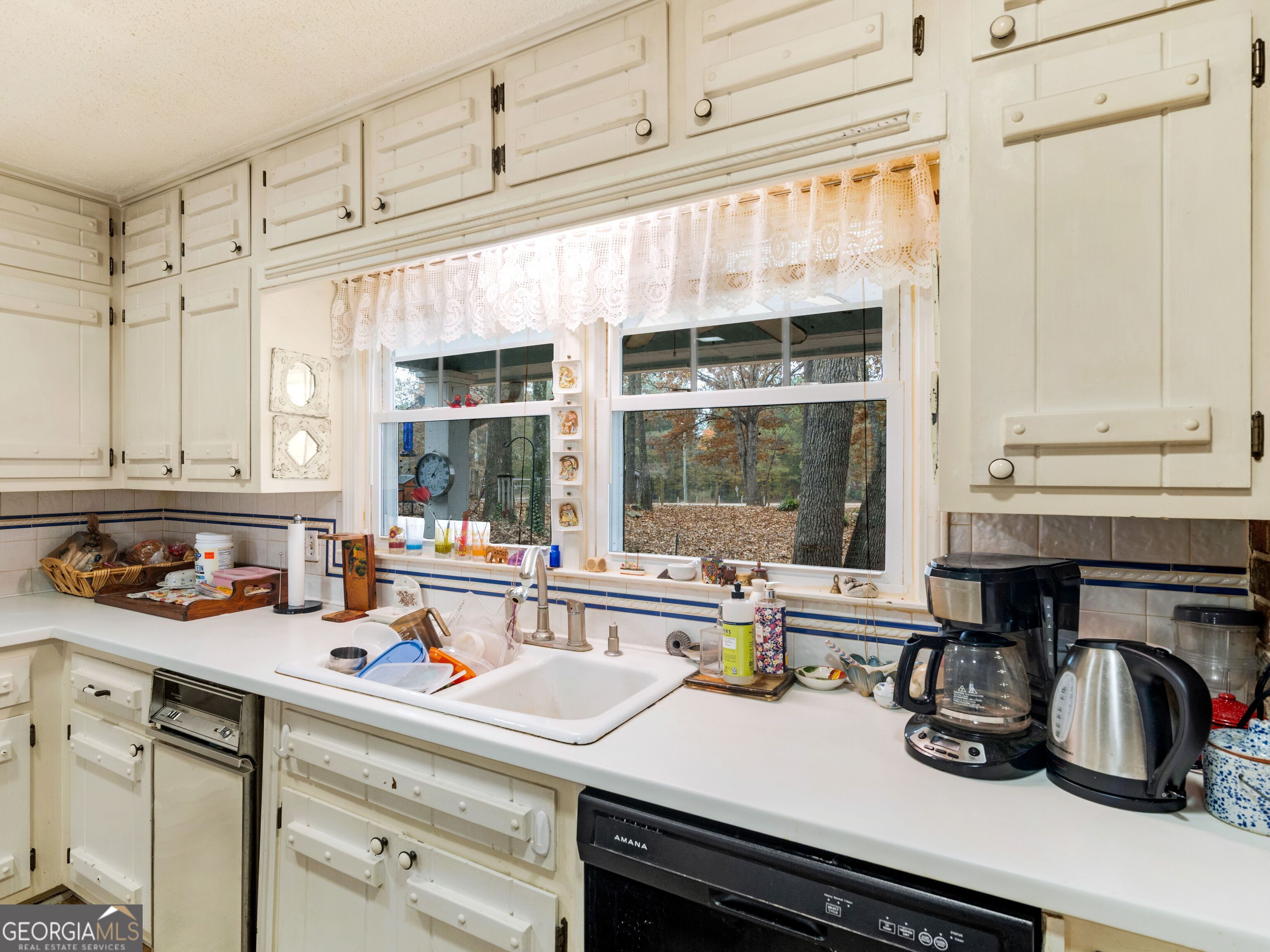 879 Rocky Creek Road Hampton, GA 30228 - Photo 8 of 29 a kitchen with a sink and cabinets