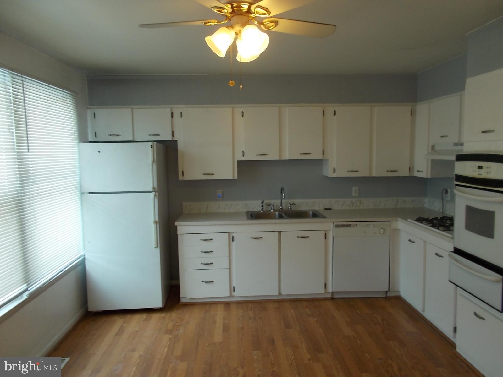 1317 Turret Road Bel Air, MD 21015 - Photo 3 of 14 a kitchen with stainless steel appliances granite countertop a refrigerator sink and white cabinets