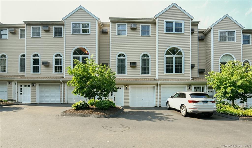 a car parked in front of a brick house with a yard