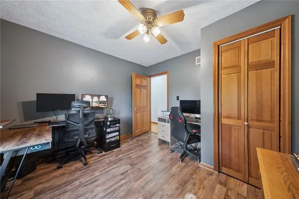 a view of a workspace with furniture and a window