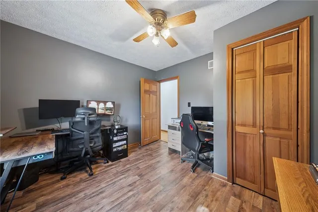 a view of a workspace with furniture and a window